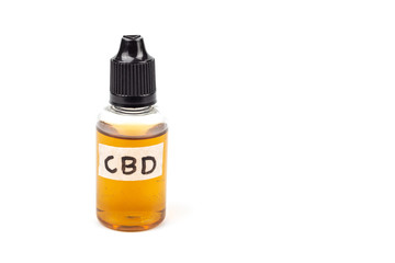 Medicinal cannabis with extract oil in a bottle isolated on white background.