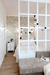 Cozy bedroom, nightstand and wardrobe. Life-changing minimalism