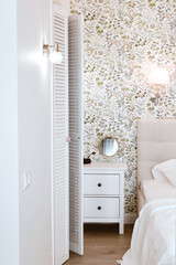 Fototapeta na wymiar Cozy bedroom, nightstand and wardrobe. Life-changing minimalism
