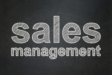 Advertising concept: text Sales Management on Black chalkboard background