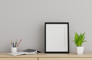 Blank black picture frame template for place image or text inside with a little tree on wood table.