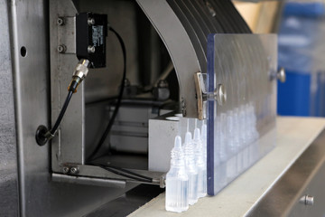 The production line of Bottle Pak. Production of nasal drops. Sterile medium. A line of bottles with medicine. Testing of the industrial line.