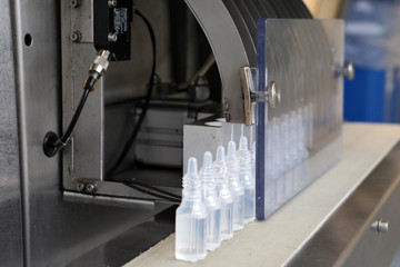The production line of Bottle Pak. Production of nasal drops. Sterile medium. A line of bottles with medicine. Testing of the industrial line.