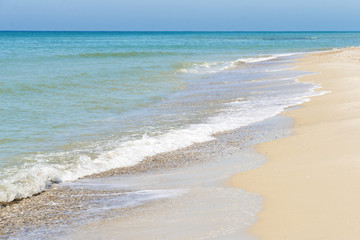 Fototapeta na wymiar Diagonal composition of sand beach shore with the blue sea