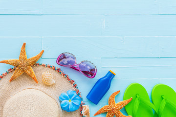 Beach accessories including sunglasses, starfish, hat beach, sunblock, colorful flip flop and shell...