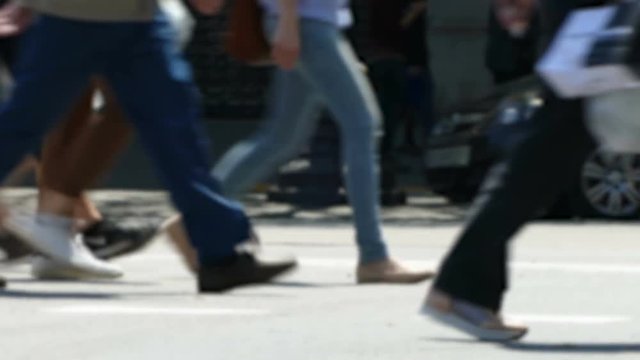 Side view blurry pedestrians walking.Time Lapse.
Detail of legs crossing a street in the city of Barcelona.