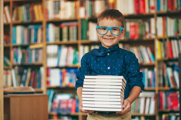 Boy with stack of books