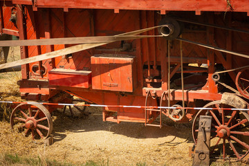 antique agricultural machines for harvesting wheat on the background of the field. harvest in the village of France. Summer agriculture-economic landscape with symbols.