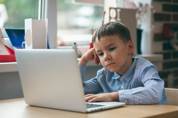 Boy focused on laptop