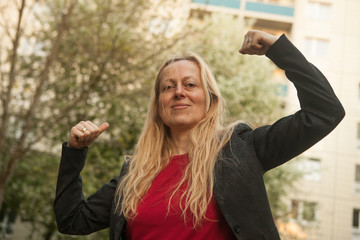 Woman making a sign of power, winning with her arms and fists