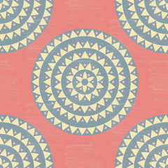 Colorful pink, yellow, gray grunge halftone ethnic tribal native mandala seamless pattern. Ornamental polka dot background with floral motifs, triangles, dots. Vector illustration.