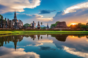 Buddha statue and Wat Mahathat Temple in the precinct of Sukhothai Historical Park, Wat Mahathat...