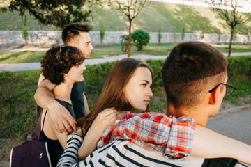 Friendship, relationships, togetherness, jealousy. Suspicious woman look at her boyfriend while walking