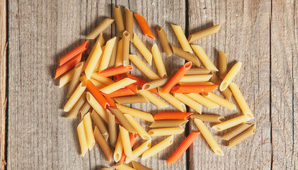 Raw homemade pasta and ingredients for pasta on wooden background