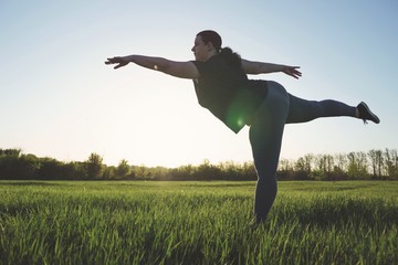 Body positive, confidence, high self esteem. Overweight woman dancing outdoors. Freedom concept