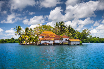 The small peninsula with the traditional buildings surrounded by the tropical plants. Idyllic place...