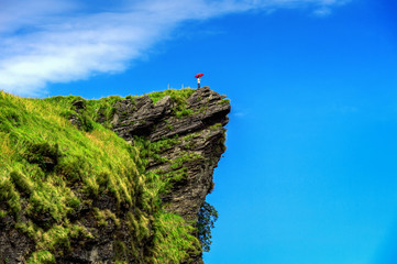 Beautiful landscape of Phu Chi Fa. Woman hand holding umbrella at Phu Chi fa National Park in...