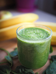 a healthy and delicious fruit cocktail with apple, banana, tasty green spinach.