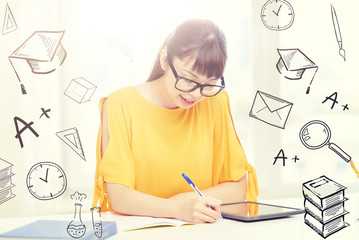 people, education, high school and learning concept - happy asian young woman student in glasses with tablet pc computer, book and notepad writing at home over doodles