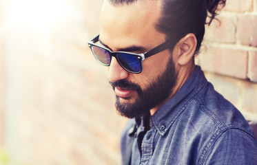 lifestyle, emotion, expression and people concept - man with beard and sunglasses on city street