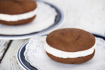 Whoopie pies or moon pies, chocolate cake desserts filled with creamy frosting 