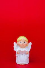 the cupid doll for the love on red background and copy space in the concept valentine's day background