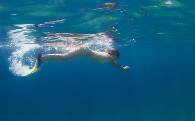 Beautifu girl swims in the sea. 