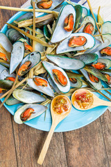 Steaming mussel With delicious sauce on dish with wood table seafood style