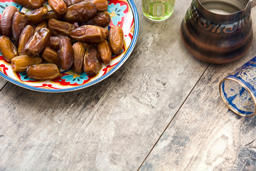 dates food in plate on wooden table. Copyspace