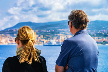 Fototapeta premium Couple looking at Mediterranean Sea and landscape Reggio Calabria
