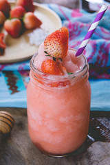 Strawberry smoothie juice ,  on topping honey tasty for summer on wood table , sweet water juice for health