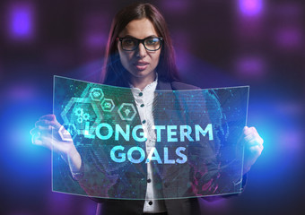 The concept of business, technology, the Internet and the network. A young entrepreneur working on a virtual screen of the future and sees the inscription: Long term goals
