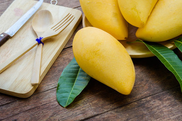 sweet yellow mango fruit on summer on wood table