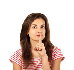 Naklejka premium Young woman holding a finger on her lips - silent gesture. emotional girl isolated on white background