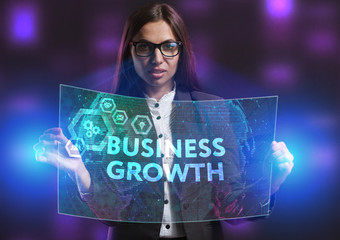 The concept of business, technology, the Internet and the network. A young entrepreneur working on a virtual screen of the future and sees the inscription: Business growth