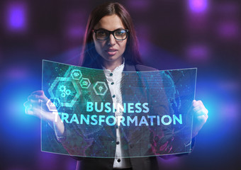 The concept of business, technology, the Internet and the network. A young entrepreneur working on a virtual screen of the future and sees the inscription: Business transformation