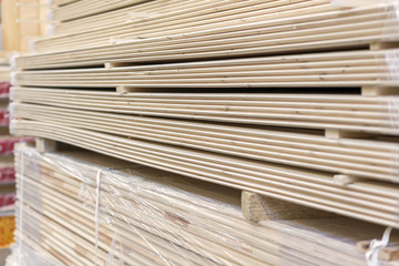 Packed boards in the building store. dry flat boards stacked together. close-up. building materials