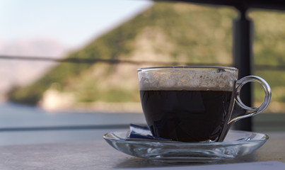 a cup of coffee in a restaurant on the beach