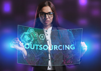 The concept of business, technology, the Internet and the network. A young entrepreneur working on a virtual screen of the future and sees the inscription: Outsourcing