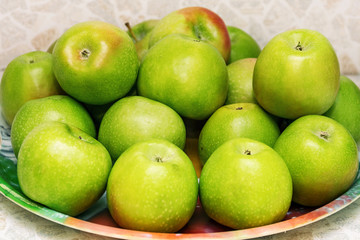 Green apples on a plate