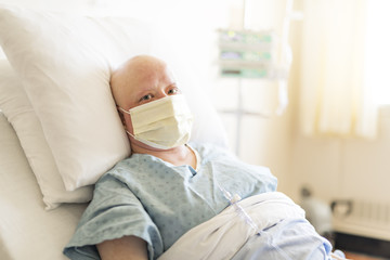woman in hospital bed suffering from cancer