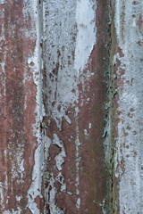 Rusty metal background with old layers of silver paint. Texture rusted shipping container