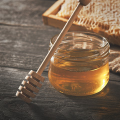 Honey background. Honey with wooden honey dipper on wooden table