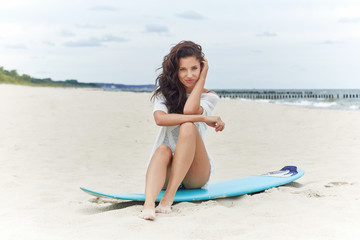 Beautiful sexy surfer girl on the beach