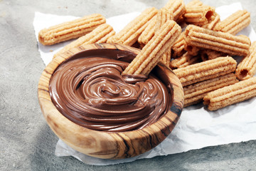 Traditional Spanish dessert churros with sugar and chocolate