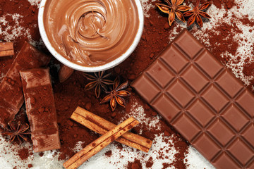 Chocolate bars on table with chocolate powder.