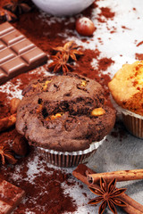 Chocolate muffin and nut muffin, homemade bakery on grey background