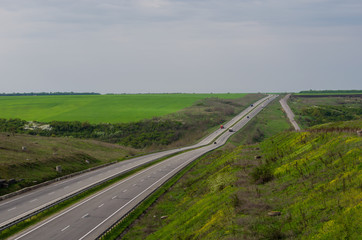 Fototapeta na wymiar A highway with green fields on both sides top view