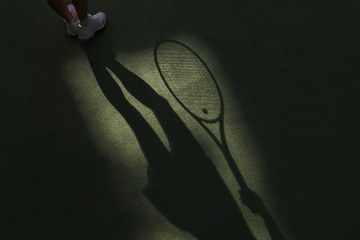Tennis competition concept shadow of Woman holding racket playing tennis