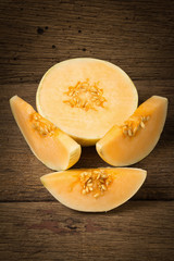 melon (sunlady) slice. half. on old wood. morning
